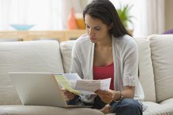 西班牙女性用笔记本电脑在线支付账单