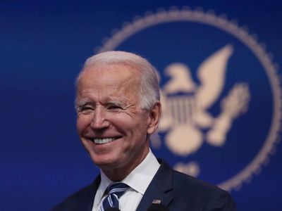 President-elect Joe Biden in front of a blue background with an eagle seal